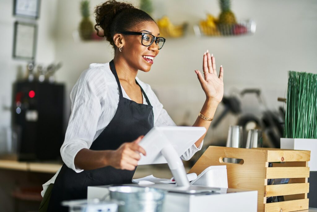 friendly waitress welcoming customers at cash register